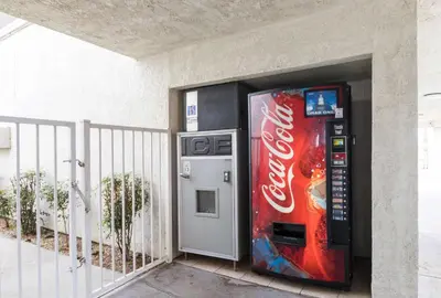 a cocacola vending machine next to a building at Motel 6 Hemet in Hemet