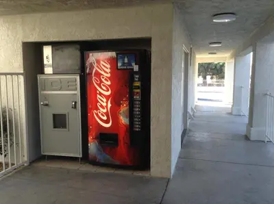a coca cola vending machine next to a building at Motel 6 Hemet in Hemet