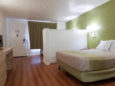 a hotel room with a bed and a television at Motel 6 Hemet in Hemet