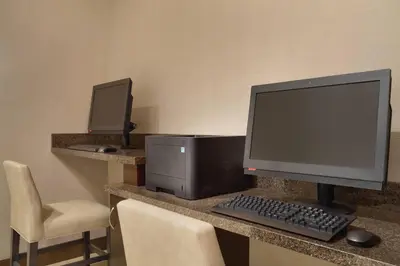 a desk with a computer and a keyboard and monitor at Residence Inn San Diego North/San Marcos in San Marcos