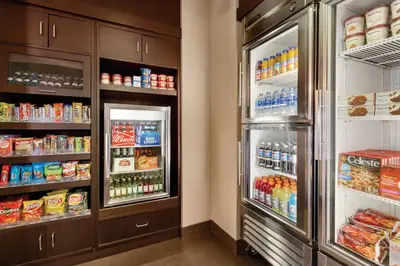 a refrigerator with its doors open and food inside at Residence Inn San Diego North/San Marcos in San Marcos