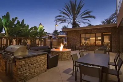 a patio with a fire pit and tables and chairs at Residence Inn San Diego North/San Marcos in San Marcos