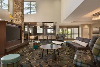 a living room with couches and a flat screen tv at Residence Inn San Diego North/San Marcos in San Marcos