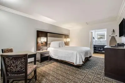 a hotel room with a bed and a desk at Rodeway Inn Old Town Temecula in Temecula