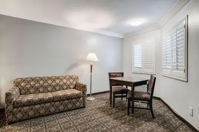 a living room with a couch and a table at Rodeway Inn Old Town Temecula in Temecula