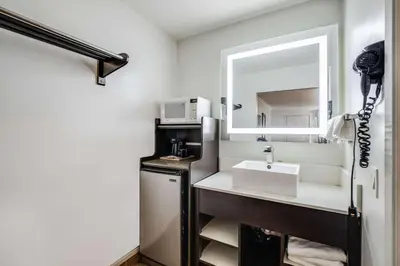 a bathroom with a sink and a mirror at Rodeway Inn Old Town Temecula in Temecula