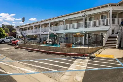 a building with a swimming pool in a parking lot at Rodeway Inn Old Town Temecula in Temecula