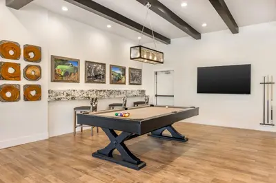 a room with a pool table and a flat screen tv at Riviera Oaks Resort in Ramona