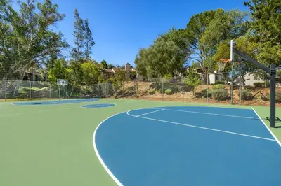 a tennis court with two tennis courts at Riviera Oaks Resort in Ramona