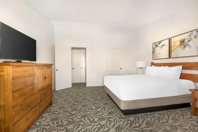 a bedroom with a bed and a flat screen tv at Riviera Oaks Resort in Ramona