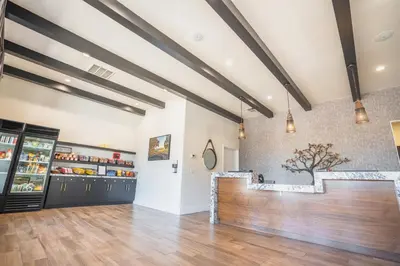 a restaurant with a counter in a room with wood floors at Riviera Oaks Resort in Ramona