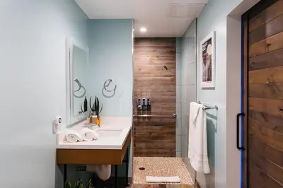 a bathroom with a sink and a shower at Surfhouse in Encinitas