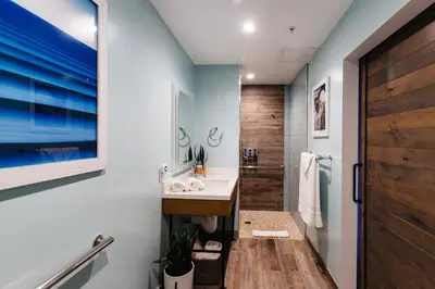 a bathroom with a sink and a shower at Surfhouse in Encinitas