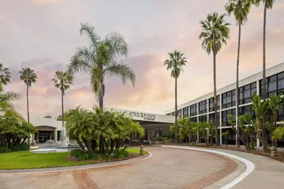 a building with palm trees in front of it at Four Points by Sheraton San Diego in San Diego