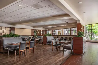 a dining room with tables and chairs in a restaurant at Four Points by Sheraton San Diego in San Diego