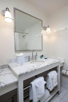 a bathroom with a sink and a large mirror at Four Points by Sheraton San Diego in San Diego