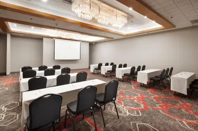 a conference room with tables and chairs and a screen at Four Points by Sheraton San Diego in San Diego