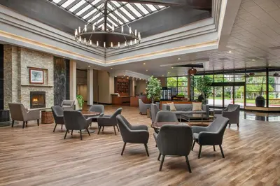 a lobby with chairs and tables in a building at Four Points by Sheraton San Diego in San Diego