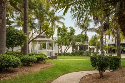 a white house with a gazebo and palm trees at Four Points by Sheraton San Diego in San Diego