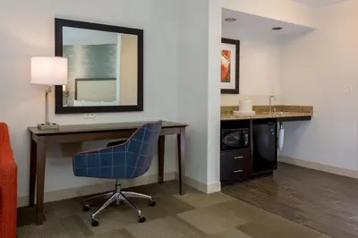 a room with a desk and a chair and a mirror at Hampton Inn & Suites San Diego-Poway in Poway