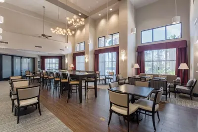 a dining room with tables and chairs and windows at Hampton Inn & Suites San Diego-Poway in Poway