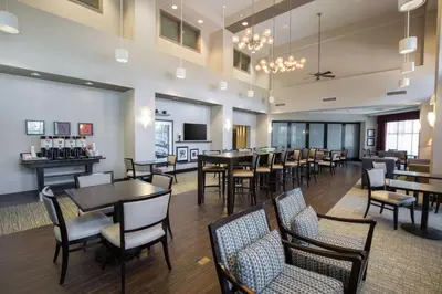 a restaurant with tables and chairs and a bar at Hampton Inn & Suites San Diego-Poway in Poway