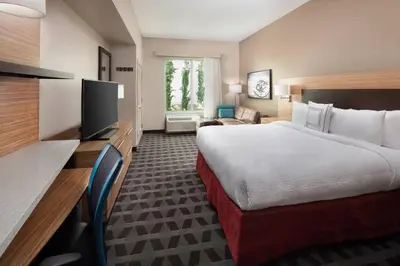 a hotel room with a bed and a flat screen tv at TownePlace Suites by Marriott San Diego Downtown in San Diego