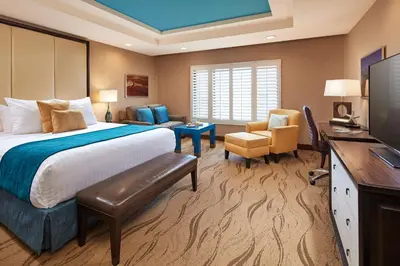a hotel room with a bed and a television at Empress Hotel La Jolla in San Diego