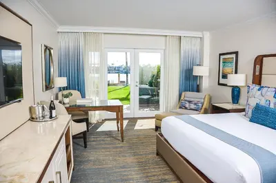 a hotel room with a large bed and a desk at Balboa Bay Resort in Newport Beach