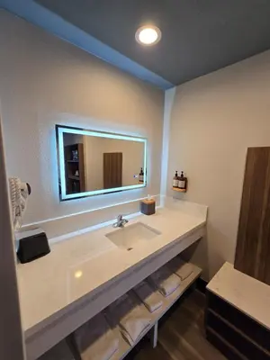 a bathroom with a sink and a mirror at Hyland Inn near Legoland in Carlsbad