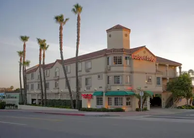 a hotel with palm trees in front of a building at Americas Best Value Inn San Clemente Beach in San Clemente