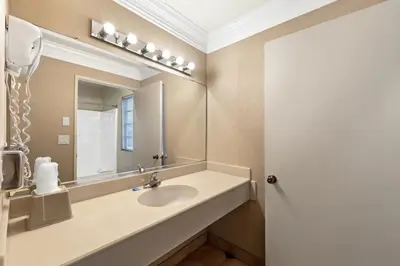 a bathroom with a sink and a mirror at Americas Best Value Inn San Clemente Beach in San Clemente