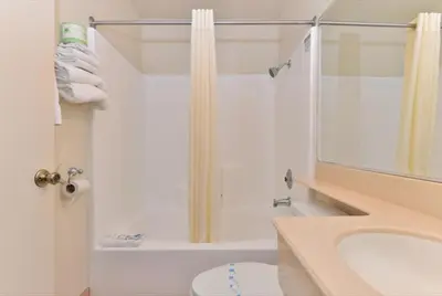 a bathroom with a shower and a toilet and a sink at Americas Best Value Inn San Clemente Beach in San Clemente