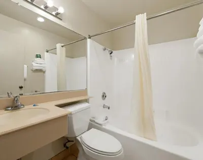 a bathroom with a toilet and a sink and a shower at Americas Best Value Inn San Clemente Beach in San Clemente