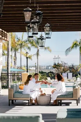 a group of people sitting around a table at a resort at The Westin Carlsbad Resort & Spa in Carlsbad