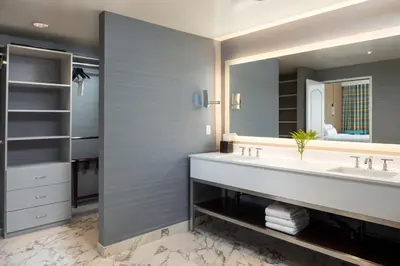 a bathroom with two sinks and a large mirror at The Westin Carlsbad Resort & Spa in Carlsbad