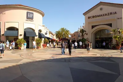 a group of people walking through a shopping mall at Carlsbad by the Sea Hotel in Carlsbad