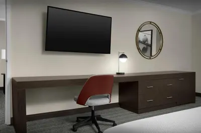a desk with a chair and a television on a wall at Courtyard by Marriott San Diego Downtown Little Italy in San Diego
