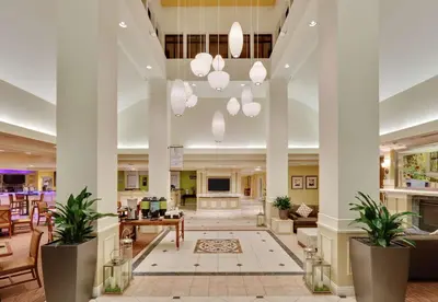 a lobby of a hotel with potted plants at Hilton Garden Inn San Diego Del Mar in San Diego