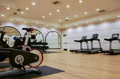 a gym with treadmills and a bike in a room at Hilton San Diego/Del Mar in San Diego