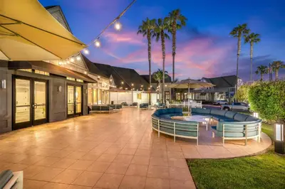 a patio with chairs and a pool at night at Hilton San Diego/Del Mar in San Diego