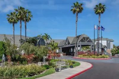 a resort with palm trees and a building at Hilton San Diego/Del Mar in San Diego