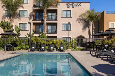 a hotel swimming pool with chairs and a building at Homewood Suites by Hilton San Diego Airport-Liberty Station in San Diego