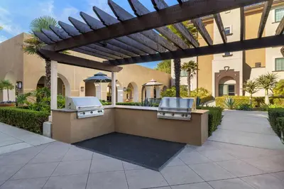 a patio with two bbqs under a pergola at Homewood Suites by Hilton San Diego Airport-Liberty Station in San Diego