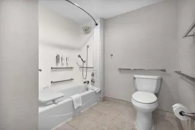 a bathroom with a toilet and a tub and a sink at Homewood Suites by Hilton San Diego Airport-Liberty Station in San Diego