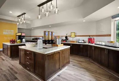 a large kitchen with wooden cabinets and a counter top at Hampton Inn San Diego/Del Mar in San Diego