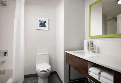 a bathroom with a toilet and a sink and a mirror at Hampton Inn San Diego/Del Mar in San Diego
