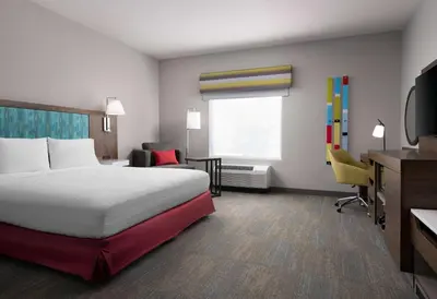 a hotel room with a bed and a desk and chair at Hampton Inn San Diego/Del Mar in San Diego