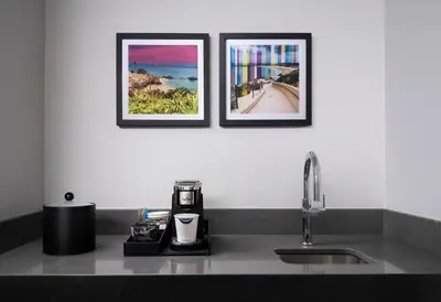 three framed pictures on a wall above a kitchen sink at Hampton Inn San Diego/Del Mar in San Diego