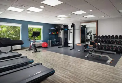 a gym with treadmills and machines in a room at Hampton Inn San Diego/Del Mar in San Diego